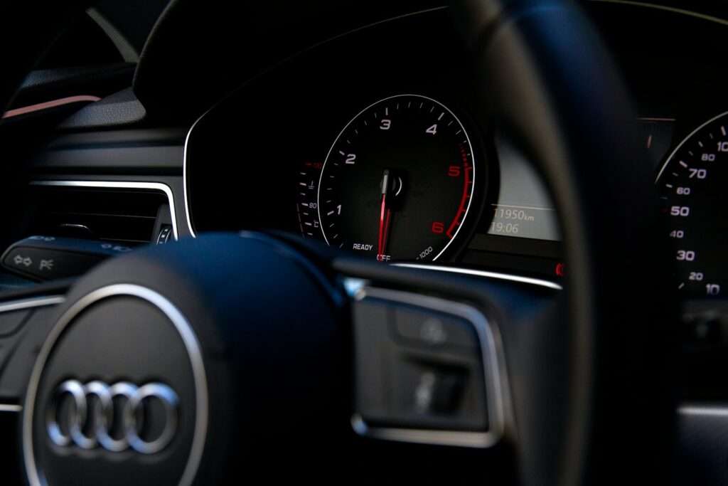 black Audi vehicle steering wheel