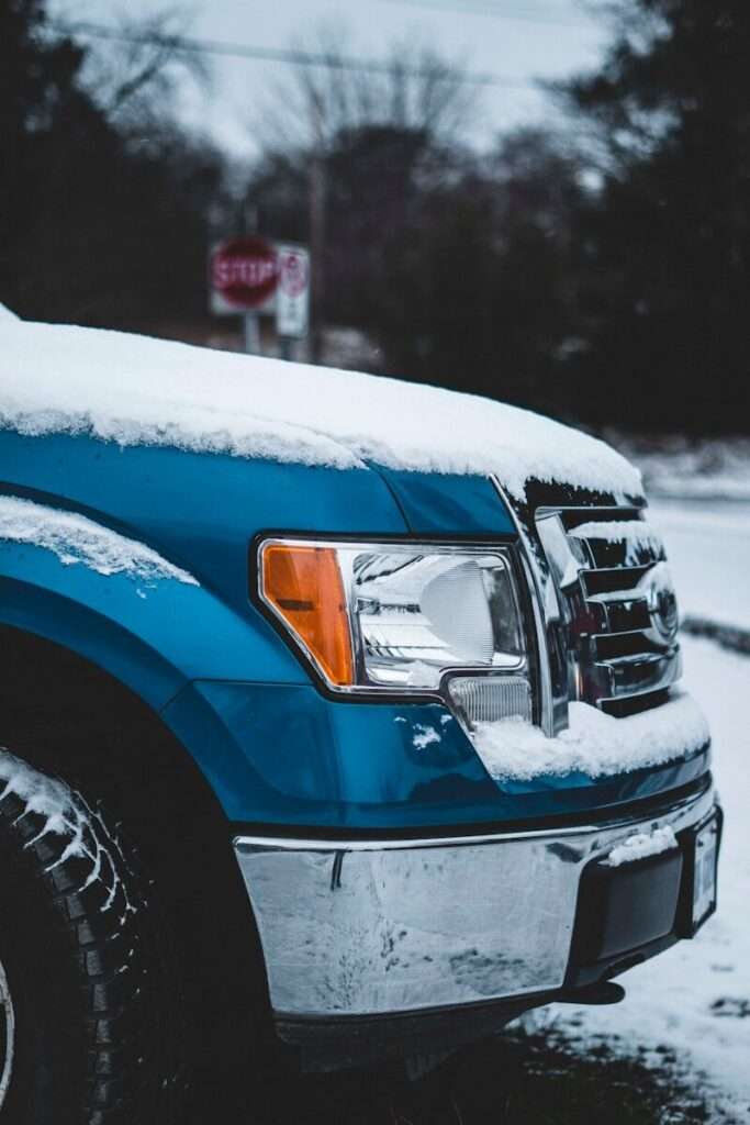 blue vehicle filled with snow