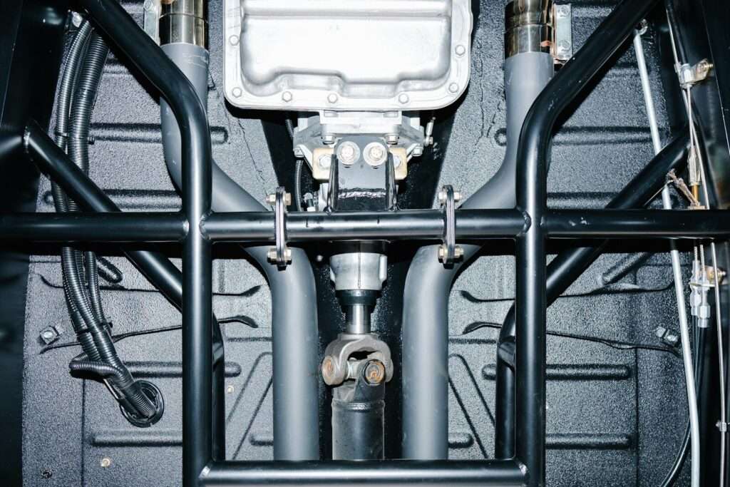Underside view of a car's drivetrain and roll cage