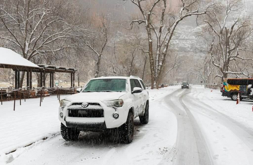 White suv driving on a snowy road
